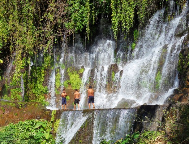 Local lads have a dip in one of the  waterfalls