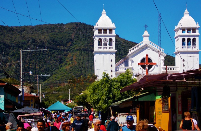 The busy streets of Juayua around the white washed church