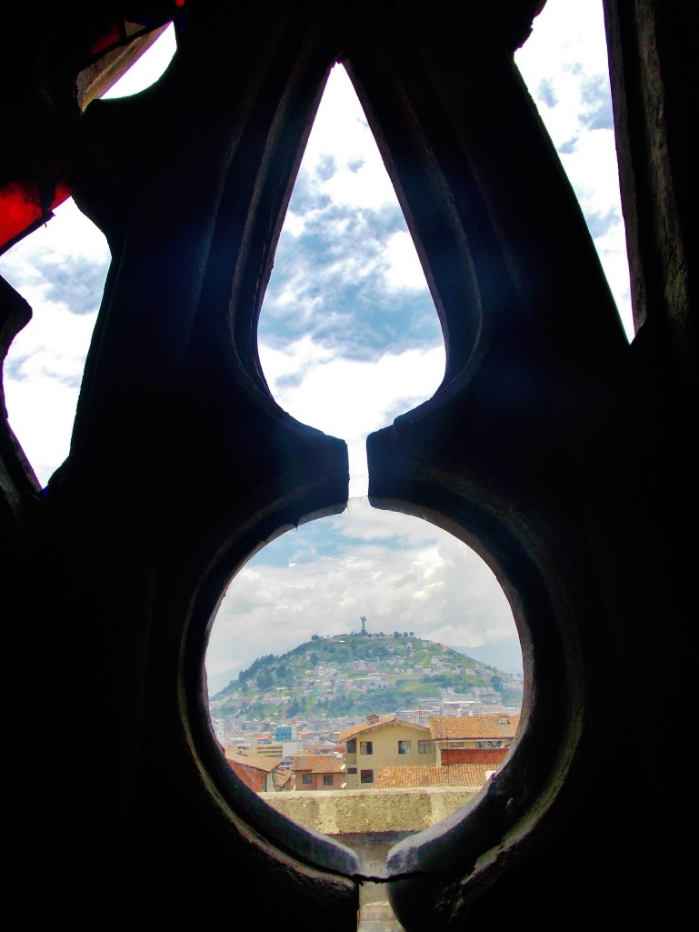 Panecillo htough a broken pane of the Basilicas stained glass
