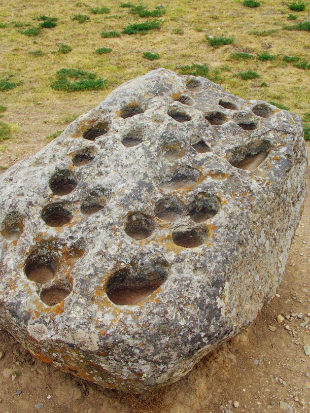Astrological rock - The holes were filled with water so they could watch the reflection of the stars
